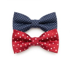 Two polka dot bow ties stacked on a white surface isolated on white background