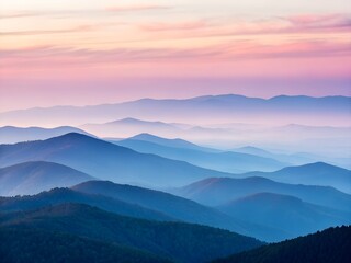 Obraz premium Misty mountain ridges at sunrise with pastel colorful sky layers