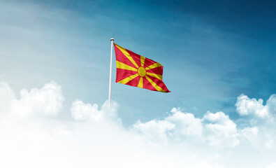 North Macedonia national flag with mast waving in beautiful sky. North Macedonia flag for Republic...