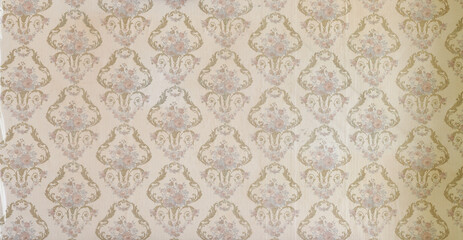 Old wallpaper on the wall. Old wallpaper for texture or background.