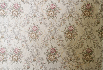 Old wallpaper on the wall. Old wallpaper for texture or background.
