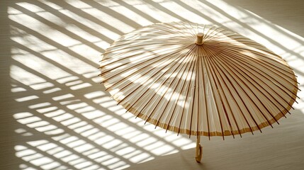Obraz premium Light, simple paper umbrella casts shadows