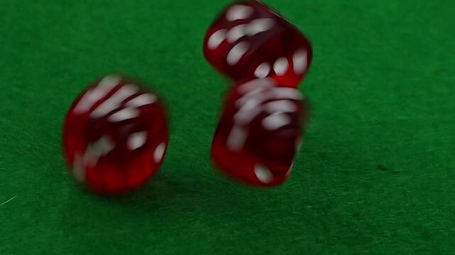 Casino dice on a green cloth close-up