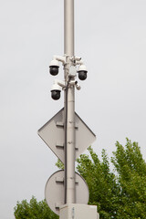 Surveillance cameras mounted on a pole against the sky