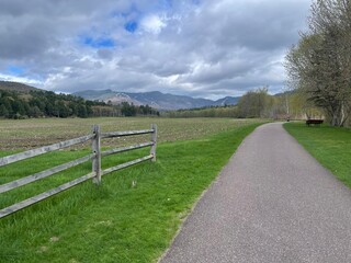 Walking bike path winds through the green countryside, farms, and mountains of Vermont in this picturesque scene