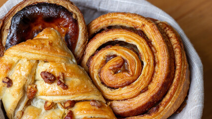 Golden swirls of buttery pastry embrace aromatic pecans, reminiscent of harvest feasts or cozy...