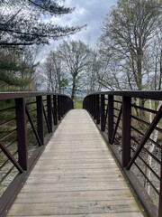 A walking bridge crosses a river in the Vermont countryside