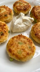 Golden potato patties dance with scallions, embracing dollops of sour creamperfect for Veselka...