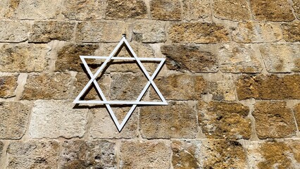 Stone wall adorned with Star of David, whispers of Hanukkah glow, sacred geometry merging with...
