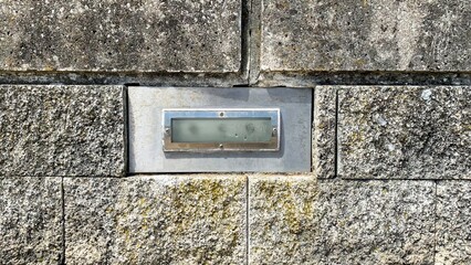 Stone-clad cryptic keypad amid ancient stone wall, hinting at clandestine passageways for Secret...
