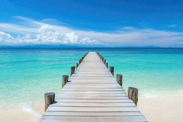 Obraz premium Tranquil wooden pier leading to a turquoise sea