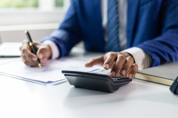 Businessman working financial documents calculating and auditing, analysis of financial figures and...