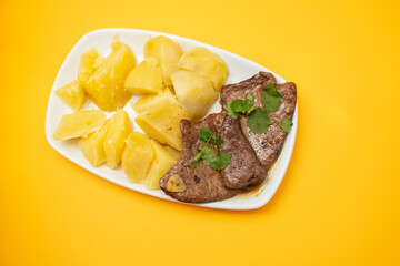 Fried Liver with boiled potato on plate