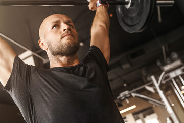 Bodybuilding, fitness and weight training with muscular man in gym for physical challenge or...