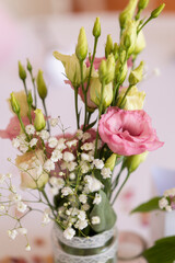 Delicate pink and white flowers creating a centerpiece for wedding reception