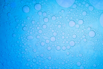 Macro blue science experiment bubble texture,A close-up of a blue liquid with bubbles in a petri...