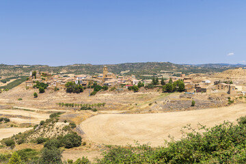Biota, located in Zaragoza, Aragon, Spain, showcases traditional architecture amidst a picturesque landscape on a sunny day
