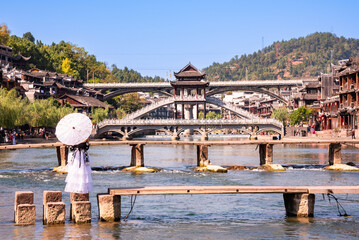 Girl in traditional clothes in Fenghuang ancient town, China.