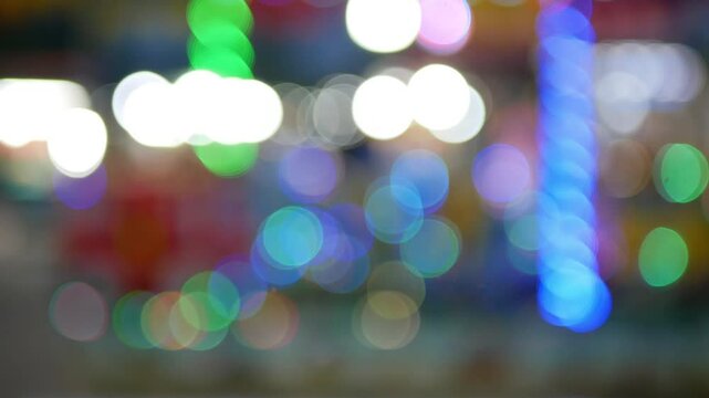 Blurry footage of circle blur or bokeh light with many colour in the night market city