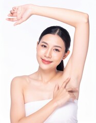 Young woman smiling while applying skincare cream on her face in a clean spa setting