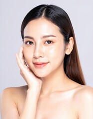 Brunette woman with glowing skin enjoying natural skincare in spa setting