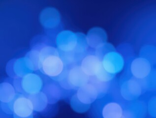 Obraz premium Abstract blue bokeh background of blurry circular lights for graphic design