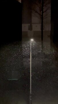 Snow reflected in the winter streetlights like snowballs