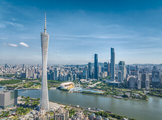 Aerial view of a modern city skyline and river in Guangzhou during the day.