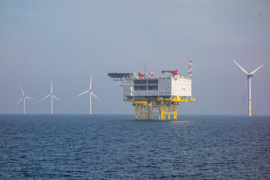 Offshore Wind Farm and Energy Platform in Open Sea. Renewable Energy Infrastructure and Sustainable Power Generation Concept for Environmental and Industrial Use