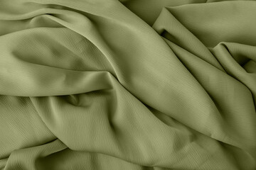 Obraz premium Elegant fabric texture in green color with soft flowing folds and creases
