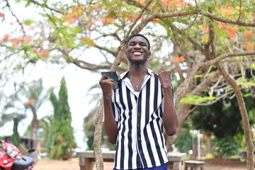 Handsome african american man outdoors using smart phone