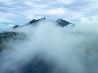 Low clouds cover the rainforest-covered, volcanic island of Damar, near Halmahera, Indonesia. This beautiful, tropical area harbors extraordinary marine and terrestrial biodiversity.