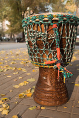 African traditional drum jembe in autumn city park