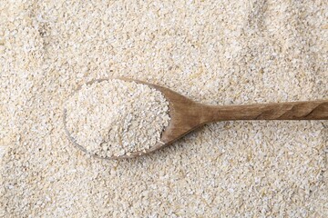 Superfood product. Oat powder and spoon as background, closeup