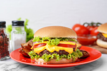 Tasty cheeseburger on white marble table, closeup
