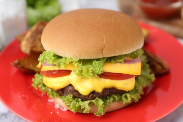 Tasty cheeseburger with lettuce and tomatoes on white table, closeup
