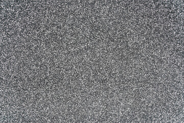 Close-up texture of a wall made of fine granite chips.