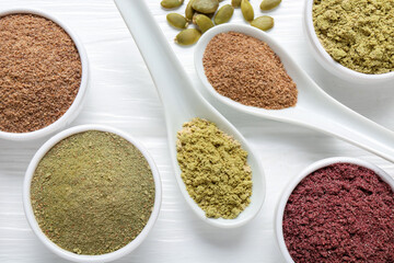 Different superfoods on white wooden table, flat lay