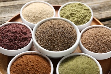 Different superfoods in bowls on table, closeup