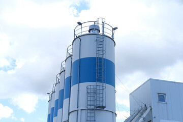 fully equipped cement plant, Large storage silos and production unit demonstrate scope contemporary...
