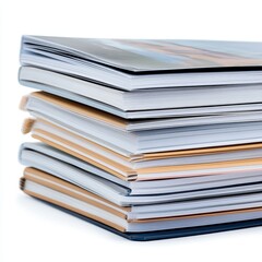 Stack of neatly arranged books with diverse covers showcasing various textures and colors isolated on a bright white background