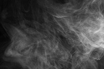 Abstract smoke texture over black background. Fog in the darkness.