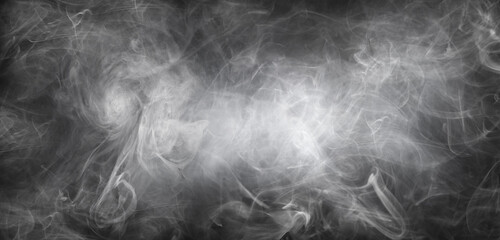 Abstract smoke texture over black background. Fog in the darkness.