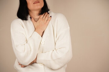 Her facial expression and posture convey a clear sense of unease. This gesture emphasizes physical...