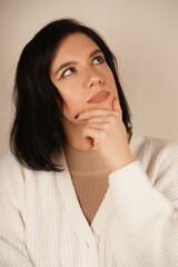 A calm pose, symbolizing mindfulness and reflection. A young woman places her hand under her chin,...