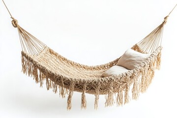 Obraz premium Beige woven hammock with tassels and a white pillow on a white background