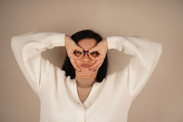 A woman playfully makes an 