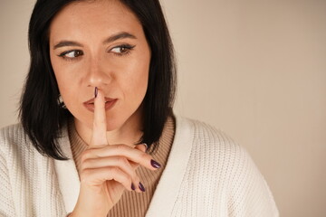 A subtle and timeless gesture, understood by all. One finger placed on the lips signals a gesture...