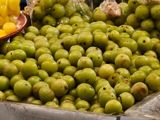 Fresh Green Fruits Displayed at Local Market on a Bright Sunny Day in Colorful Baskets