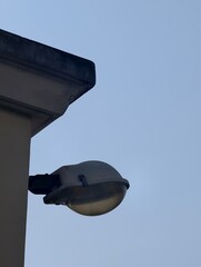 Street Lamp Against Clear Blue Sky in Urban Setting with Minimalist Architectural Elements